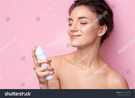 Стоковая фотография 2021029736 Beautiful Woman Using Spray Thermal