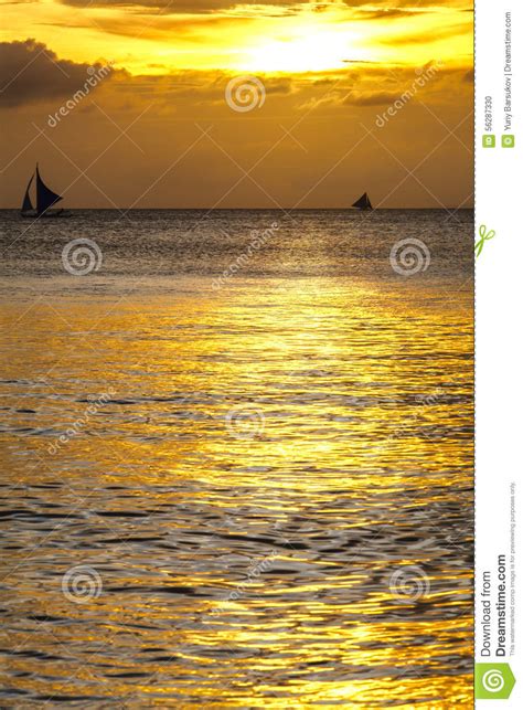 Silhouette Of Sailing Boats On Horizon Of Tropical Sunset Sea