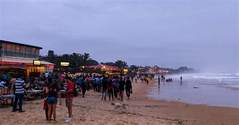 People Enjoying An Evening In Baga Beach In Goa Besides The Sea And The