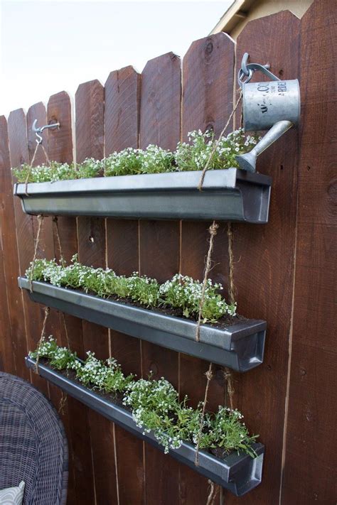 It's an excellent option for growing an indoor herb garden. do it herself hanging gutter planter | Vertical garden diy ...
