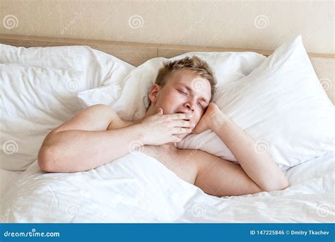 Funny Guy In Bed Under The Blanket After Sleeping Sleepy Man Waking Up Stock Photo Image Of