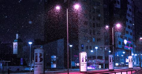 Street Lights Turned On Near Buildings At Night · Free Stock Photo