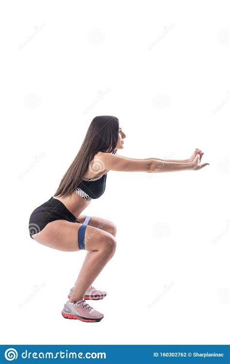 Side View Of Fitness Woman Doing Leg Exercises Squatting With