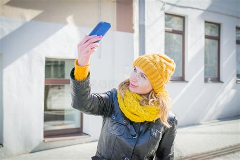 Portrait Of An Attractive Woman Taking Selfie On City Streets Stock