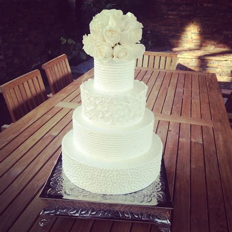This handmade buttercream cake was made without the use of fondant. BAKESHOPmarie: white buttercream wedding cake with white roses