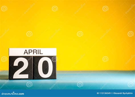 April 20th Day 20 Of April Month Calendar On Table With Yellow