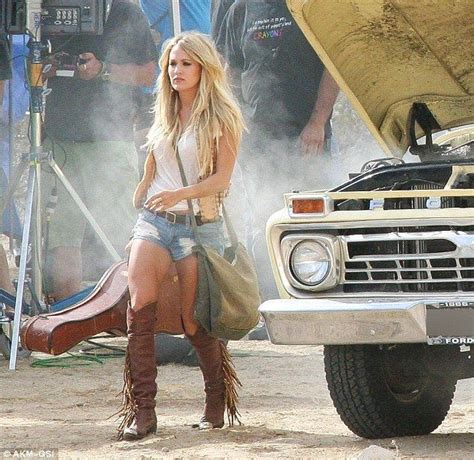 Carrie Underwood Flashes Toned Legs In Daisy Dukes As She Films Video Music Festival Outfit