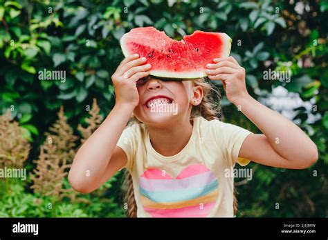 Happy Kid Eating Watermelon And Having Fun Outdoor In Summer Day Funny