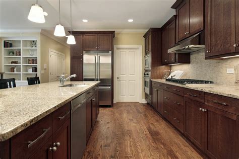 Featuring a wide open floor plan, this kitchen is highlighted by cupboard doors on every usable surface, including the matching refrigerator. 46 Kitchens With Dark Cabinets (Black Kitchen Pictures)