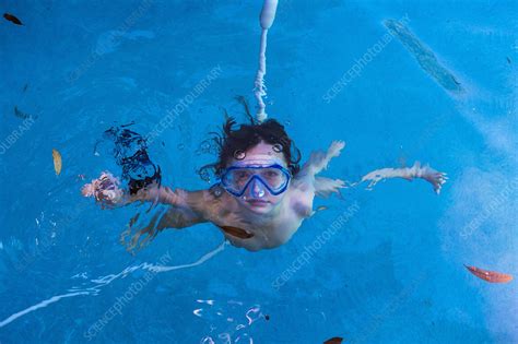 A Boy Swimming Underwater In A Pool With Goggles Stock Image F032