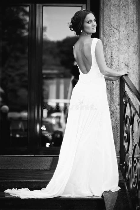 Beautiful Brunette Bride In White Dress Walking Up Stairs Stock Photo