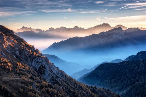 Mountains In Fog At Beautiful Sunset In Autumn In Dolomites Italy