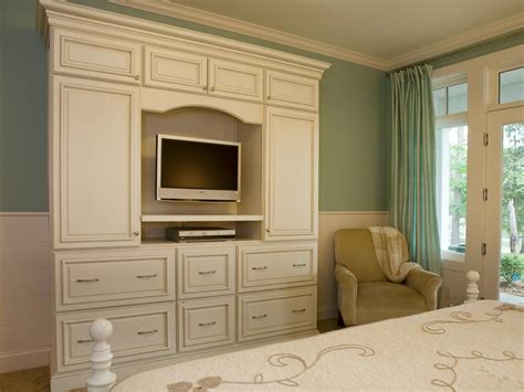White Entertainment Center With Molding in a Traditional Bedroom