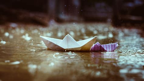 Two Paper Boats In Monsoon In Water Puddle Stock Photo Download Image