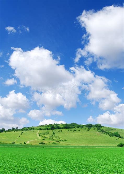 Idyllic View Green Hills And Blue Sky With White Clouds Stock Photo