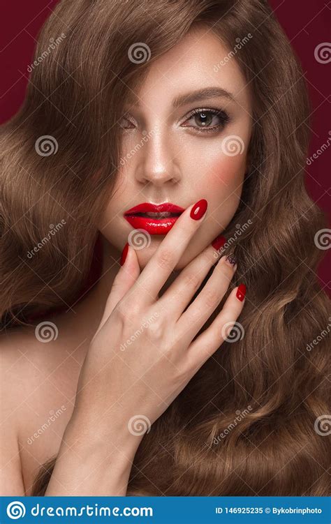Beautiful Girl With A Classic Makeup Curls Hair And Red Nails