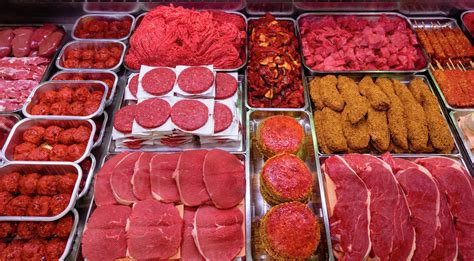 Variety Of Marinated Meat At Display Counter In Butchers Shop Stock