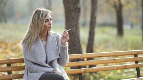 Young Beautiful Business Woman Smoking A Cigarette In The Park Autumn