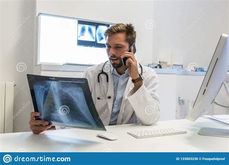 Serious Attractive Doctor Examining An X Ray Stock Photo Image Of