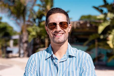 Portrait Of Happy Caucasian Man Looking At Camera And Smiling At Beach