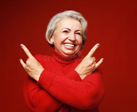 Elderly Woman Laugh And Showing Rock Sign At Camera Emotion And