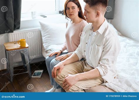 Despaired Married Couple Sitting On The Edge Of The Bed Stock Image