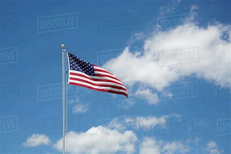 American Flag Against Cloudy Sky Stock Photo Dissolve