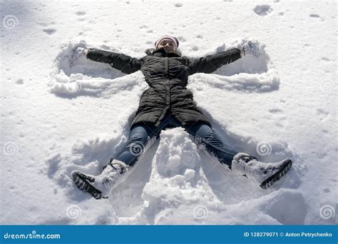 Happy Young Woman Lying On Snow Fur In Wintertime Young Happy Woman