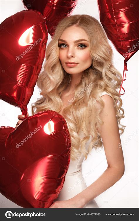 Sexy Woman In White Dress And Balloons With Hearts Posing In The Studio