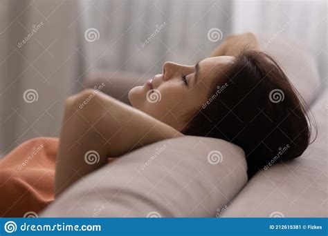 Calm Teen Female Lying On Couch Rest With Closed Eyes Stock Image