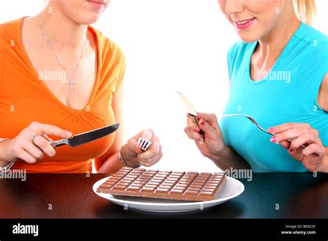 Young Women Eating Bar Of Chocolate Model Released Stock Photo Alamy