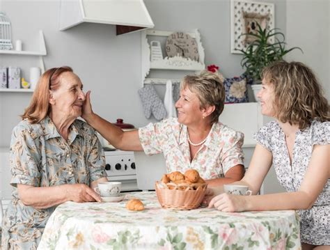 Free Photo Mature Woman Stroking Her Senior Mother While Having Breakfast
