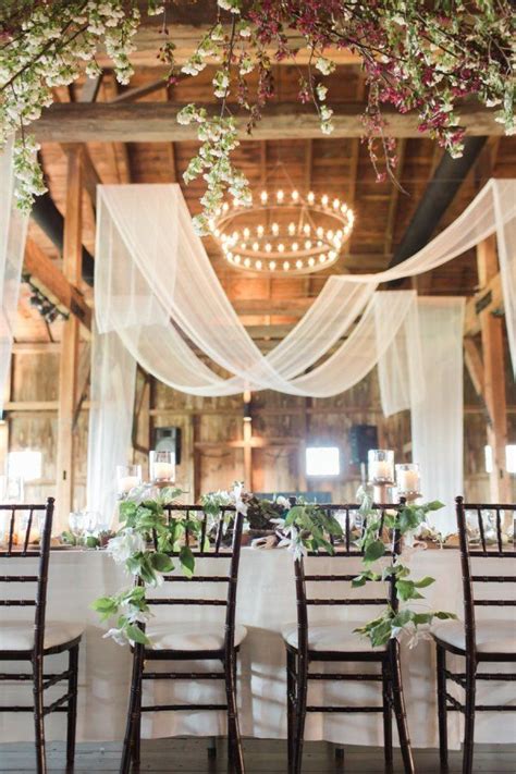 Barn Wedding Reception With A Draped Entrance Roses And Rings