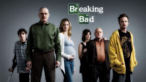 A Group Of People Standing Next To Each Other In Front Of A Breaking