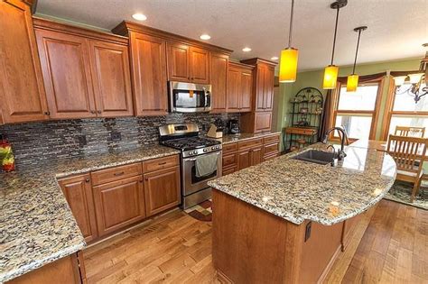 Maple is the one of the hardest and second most popular of all the cabinet woods. Cabinets: StarMark Cabinetry Ridgeville door in Cherry ...