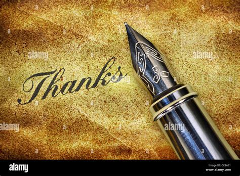 Closeup Of A Fountain Pen And Word Thanks Written On Grunge Background
