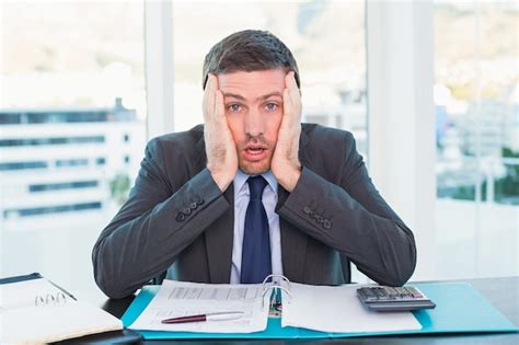 Premium Photo Stressed Businessman With Head In Hands