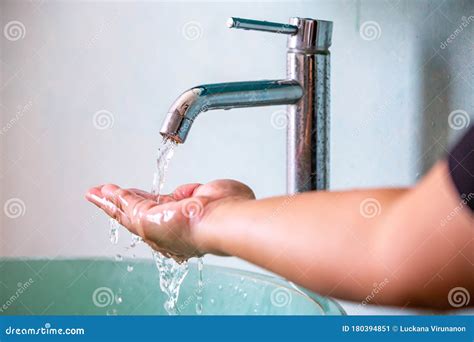 Water Flowing From Faucet To Her Hand Green Washbasin Bathroom