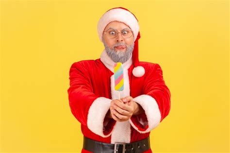 Premium Photo Santa Claus Holding Out Sugary Ice Cream Looking With