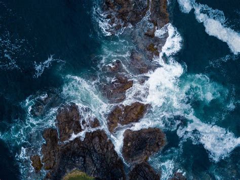 Aerial Shot Of Waves Hitting Rocks On Ocean Coast Stock Photo Image