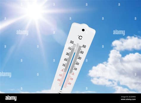 Outdoor Thermometer Indicating High Temperatures Against Blue Summer