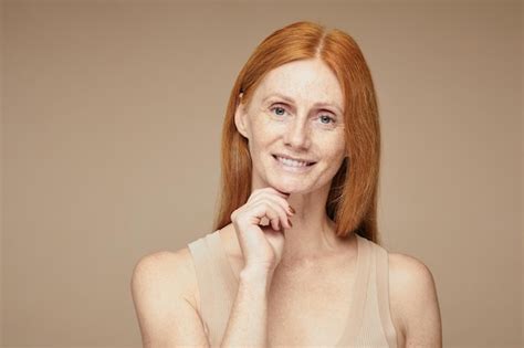 Premium Photo Minimal Portrait Of Freckled Red Haired Woman Smiling At Camera While Wearing