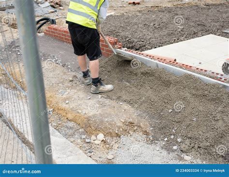 Installation Of Edging Pin Kerb On Semi Dry Concrete During Footpath