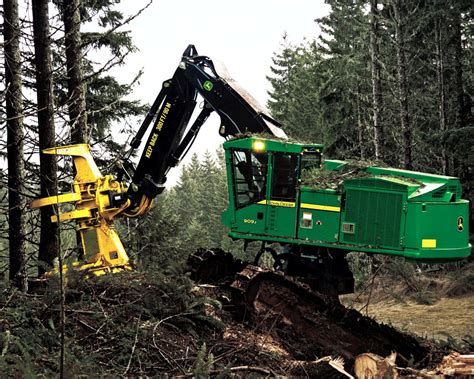 a large green machine in the middle of a forest