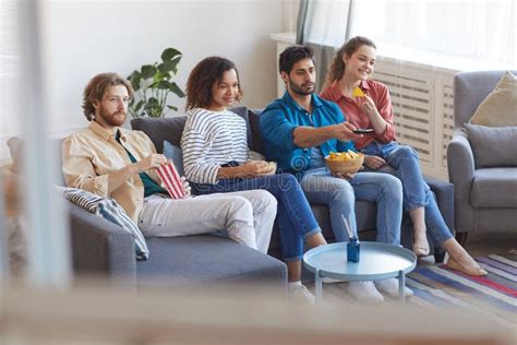 Multi Ethnic Group Of People Watching Tv At Home Stock Photo Image Of