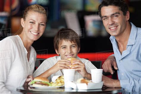 Popeyes prices are very competitive to rest of the industry, and if you are planning on feeding your entire family, try their family meals which offer a much better value. Family eating together in fast food restaurant, portrait ...