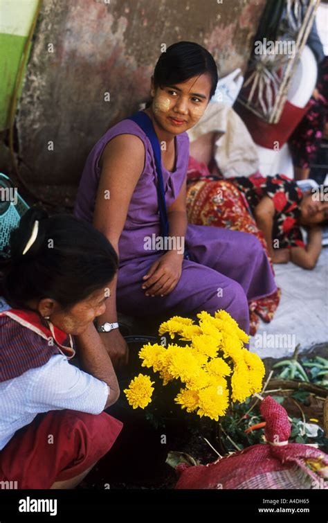 A Female Flower Seller At A Street Market Yangon Rangoon Myanmar