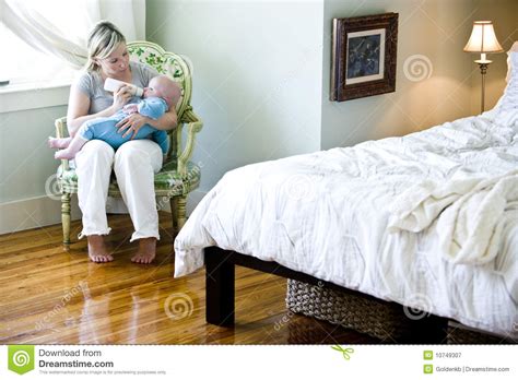 Create the bedroom you really want without breaking your budget. Mother Bottle-feeding Baby In Bedroom Stock Image - Image ...