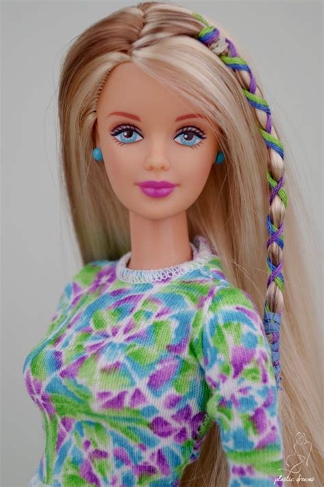 A Barbie Doll With Long Blonde Hair Wearing A Colorful Dress And Braids On Her Head