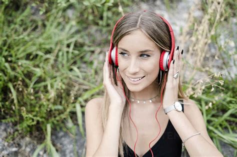 Portrait Of Smiling Teenage Girl Wearing Headphones Stock Photo